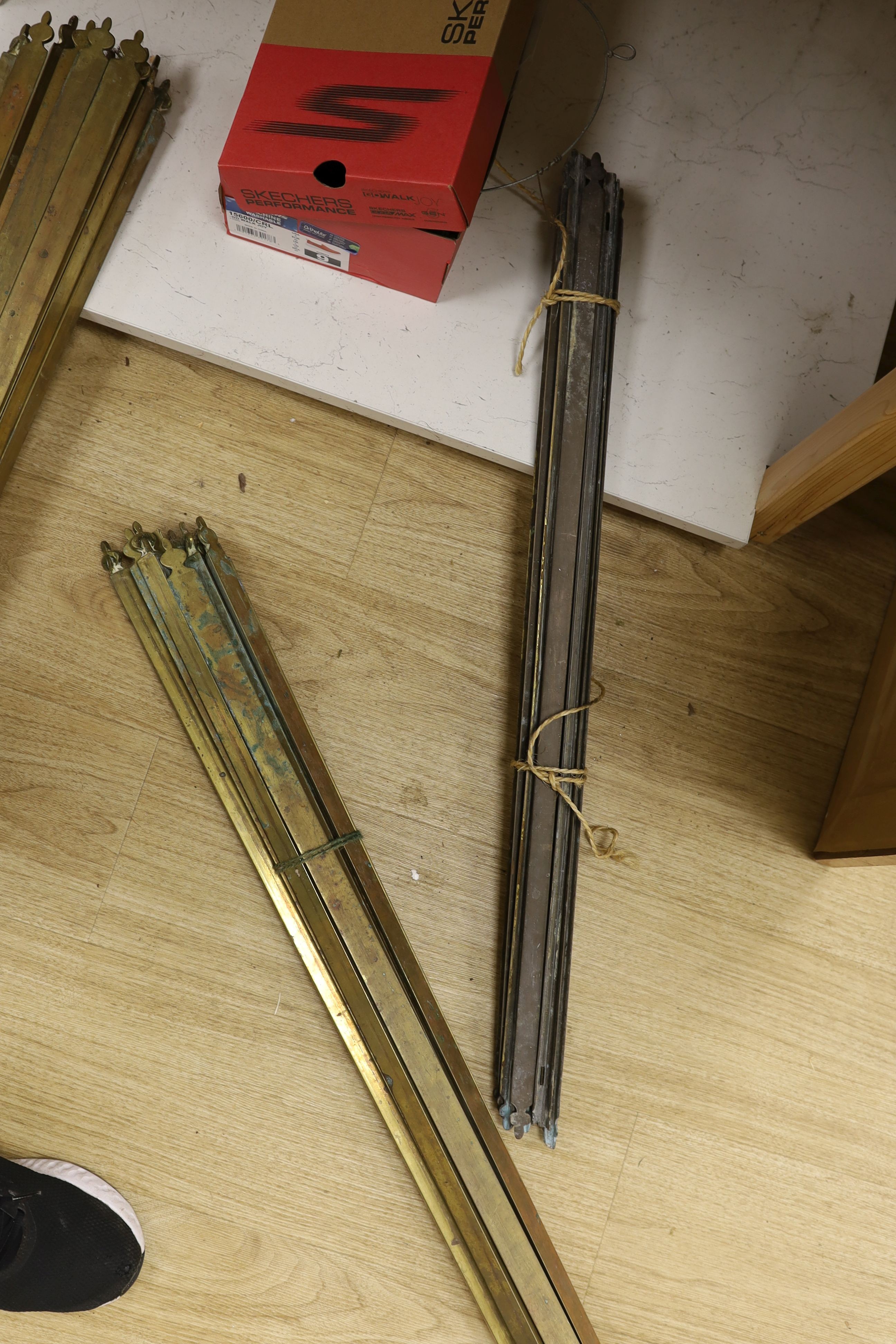 Two sets of brass stair rods with fittings.